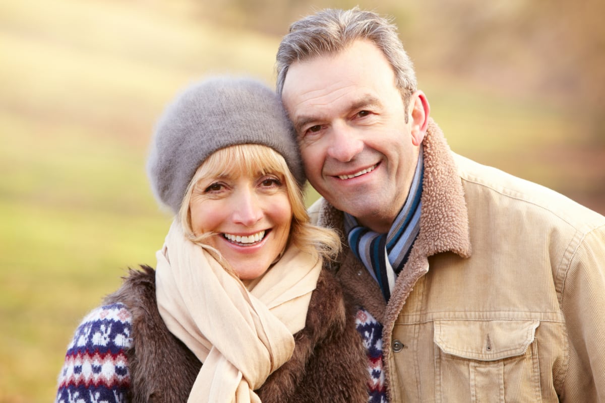 Retired couple smiling in a park